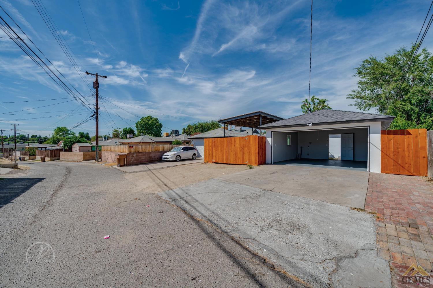 Undisclosed Address Bakersfield, CA 93305 - Photo 25 of 28 a front view of a house with a yard and a garage