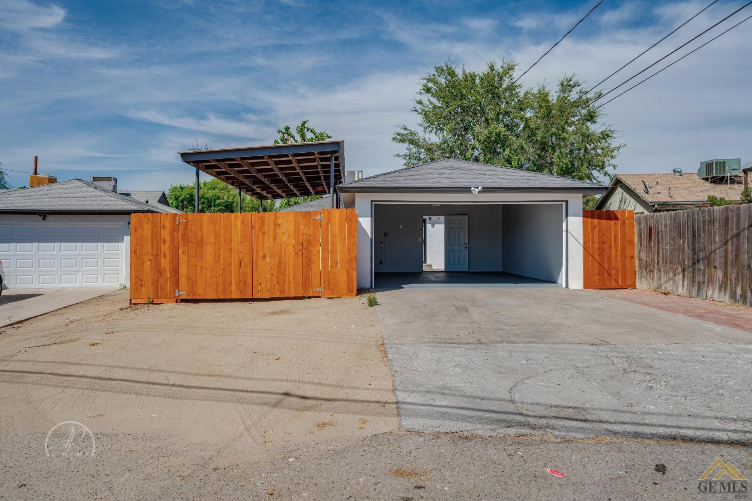 Undisclosed Address Bakersfield, CA 93305 - Photo 26 of 28 a front view of a house with a yard and garage