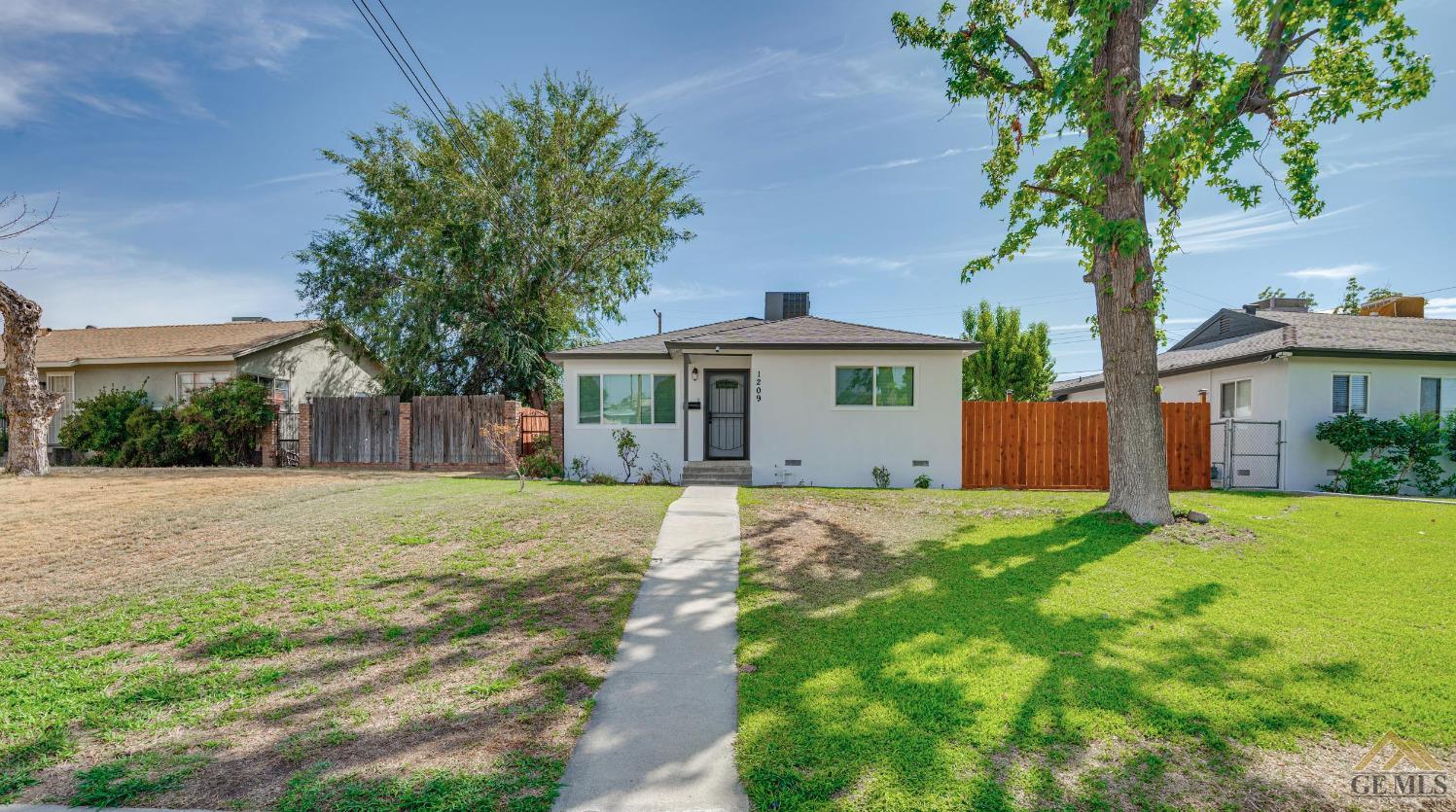 Undisclosed Address Bakersfield, CA 93305 - Photo 27 of 28 a front view of a house with a yard and garage