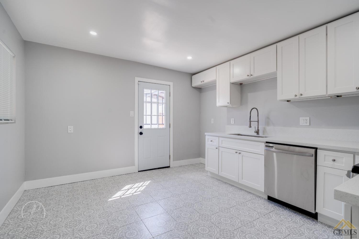 Undisclosed Address Bakersfield, CA 93305 - Photo 4 of 28 a kitchen with sink and cabinets