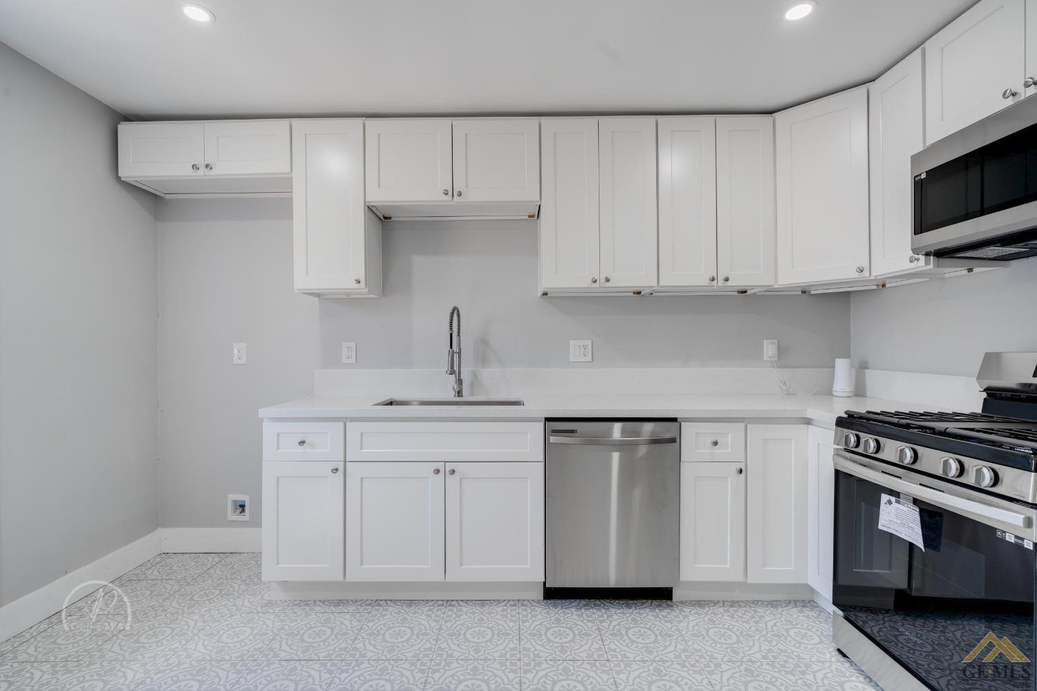 Undisclosed Address Bakersfield, CA 93305 - Photo 5 of 28 a kitchen with cabinets appliances and a sink