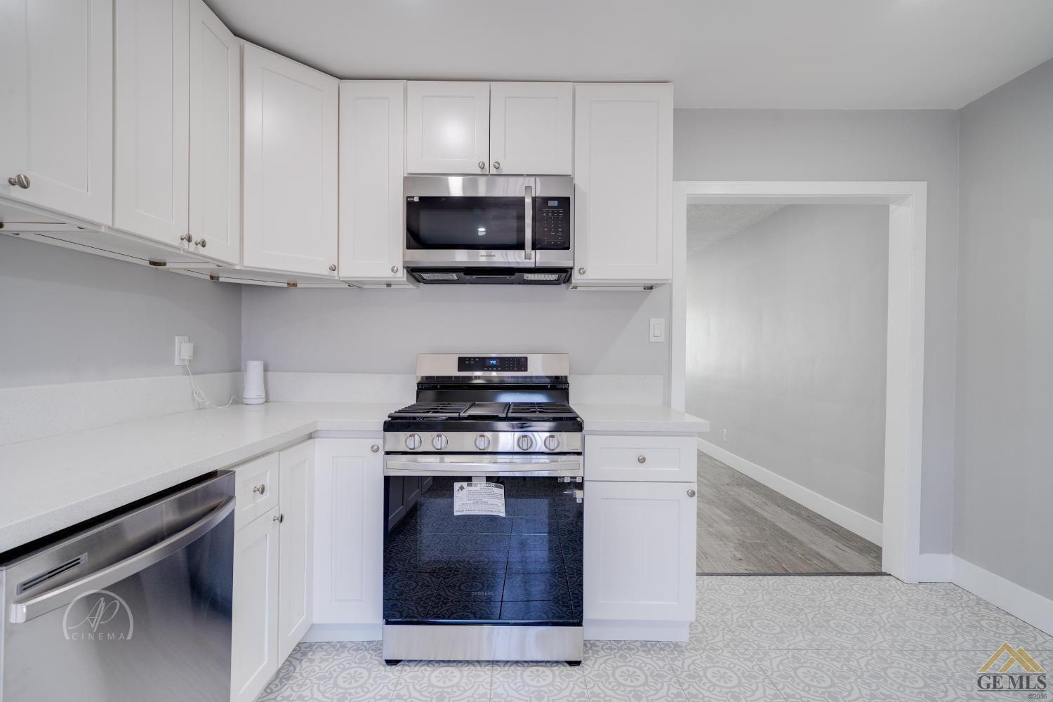 Undisclosed Address Bakersfield, CA 93305 - Photo 6 of 28 a kitchen with stainless steel appliances granite countertop white cabinets and a stove top oven