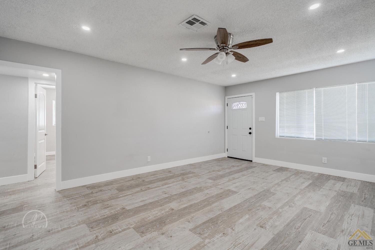 Undisclosed Address Bakersfield, CA 93305 - Photo 8 of 28 wooden floor in an empty room with a ceiling fan
