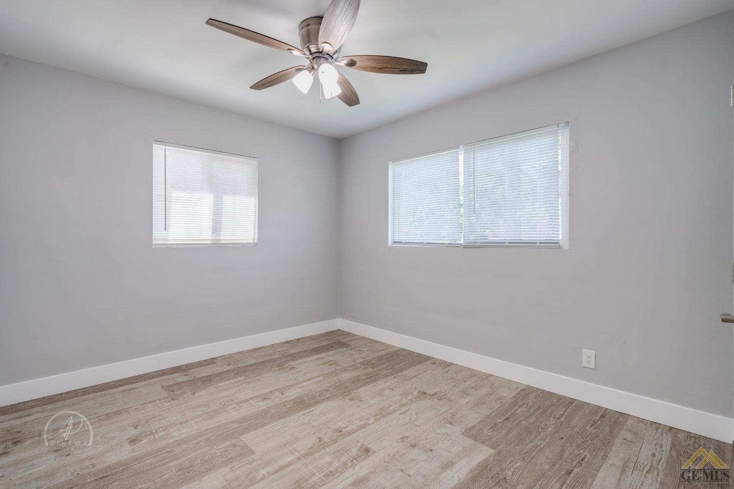 Undisclosed Address Bakersfield, CA 93305 - Photo 9 of 28 a view of empty room with wooden floor and fan