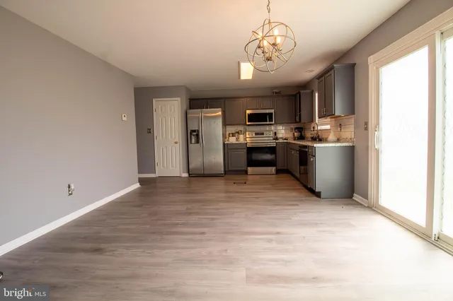 a view of kitchen with stainless steel appliances granite countertop cabinets and outdoor space