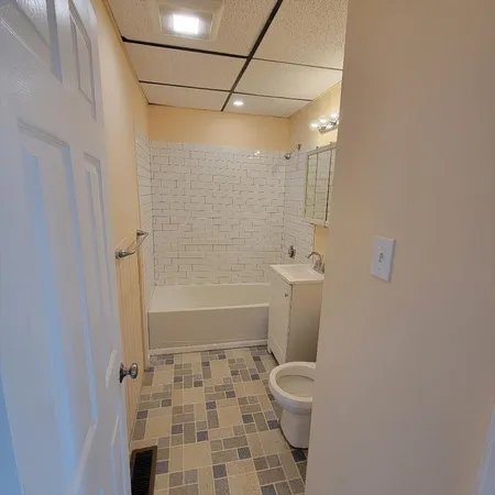 a bathroom with a toilet and a shower