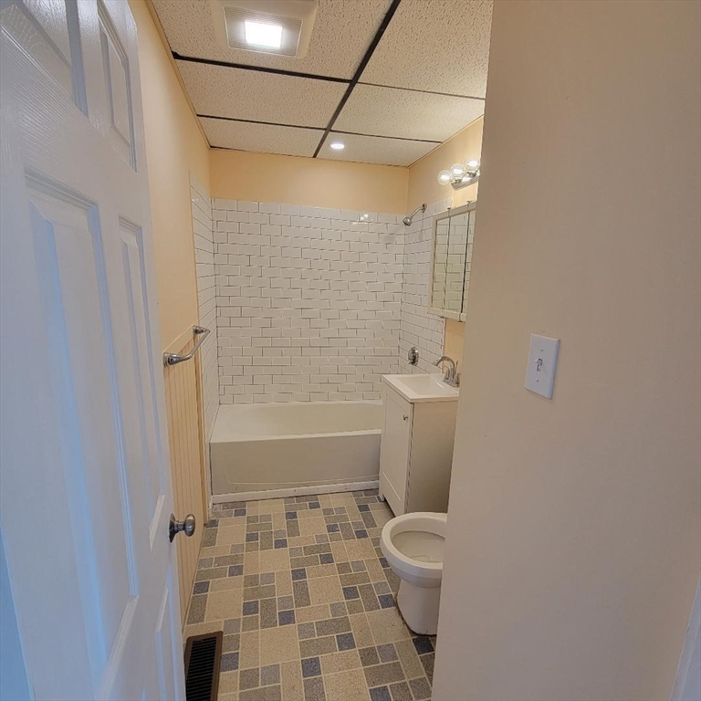 111 Rodney Street, Unit 1 Worcester, MA 01605 - Photo 8 of 9 a bathroom with a toilet and a shower