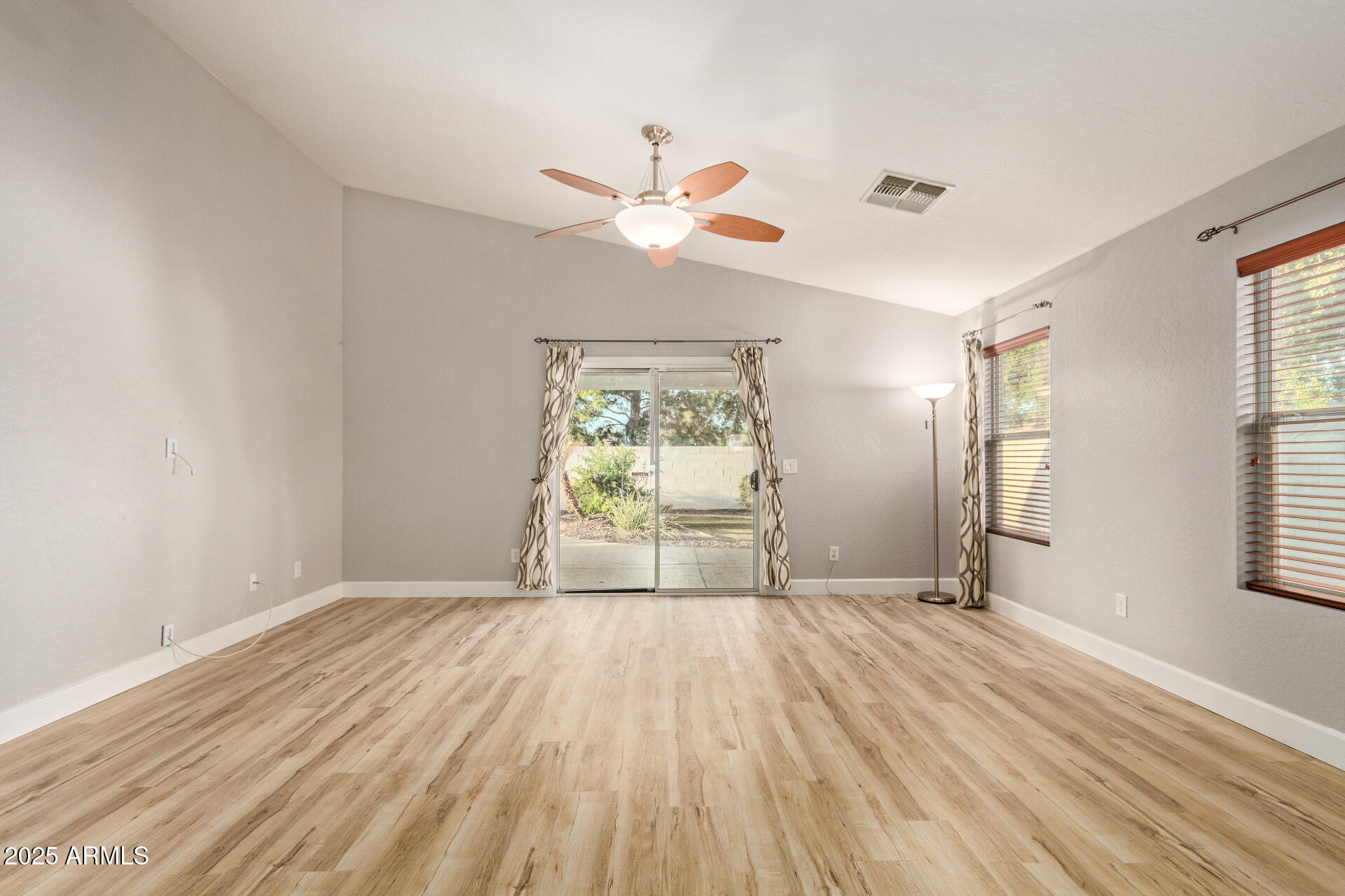 2020 West Carter Road Phoenix, AZ 85041 - Photo 3 of 32 wooden floor in an empty room with a window