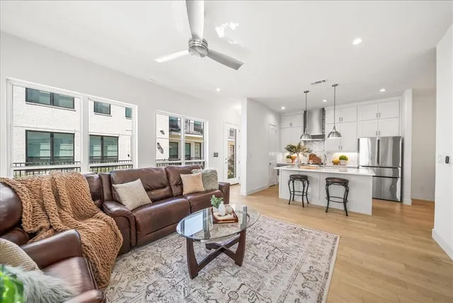 a living room with furniture and kitchen view