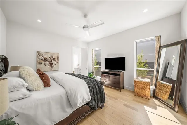 a bedroom with a bed and a flat screen tv