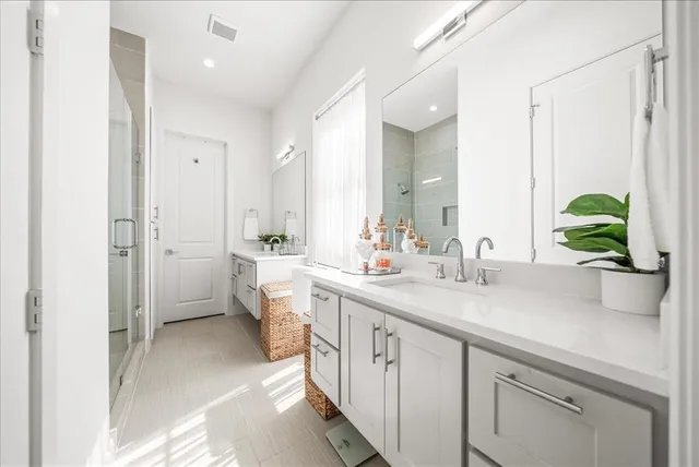 a spacious bathroom with a double vanity sink mirror and toilet