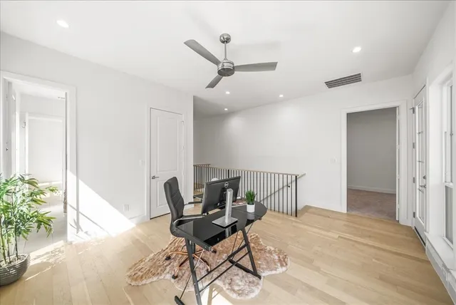 a work room with furniture and a potted plant