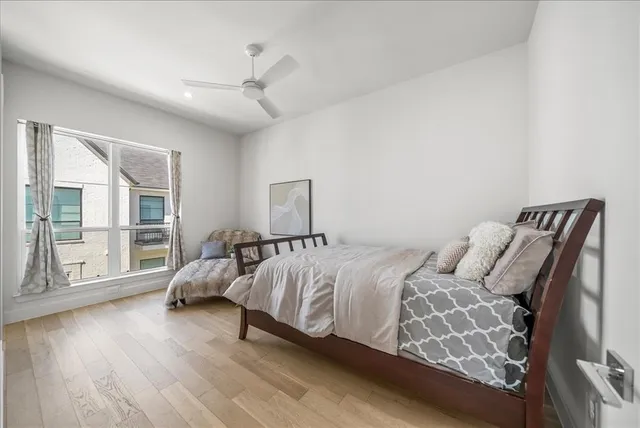a bedroom with a bed and wooden floor