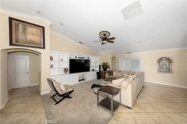 a living room with furniture a rug and a book shelf