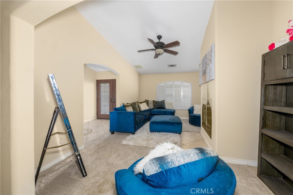 24625 Ledbury Road Oro Grande, CA 92368 - Photo 39 of 51 a living room with furniture a rug and a book shelf
