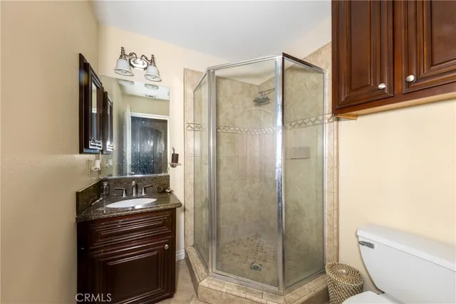 a spacious bathroom with a granite countertop sink a mirror and a bathtub