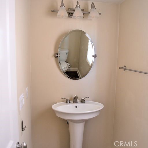 56 Twin Gables Irvine, CA 92620 - Photo 17 of 32 a bathroom with a sink and a mirror