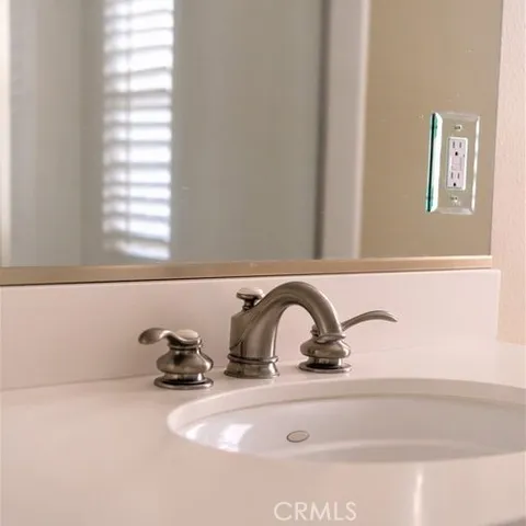a bathroom with a double vanity sink bathtub and next to a window