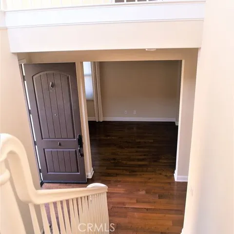 a kitchen with stainless steel appliances granite countertop a refrigerator a stove a sink and white cabinets