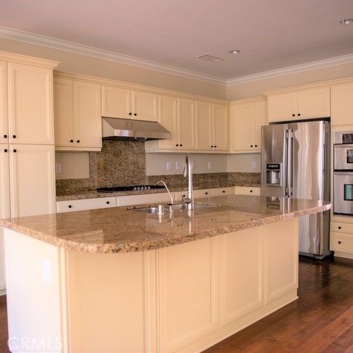 56 Twin Gables Irvine, CA 92620 - Photo 8 of 32 a kitchen with stainless steel appliances granite countertop a refrigerator a stove a sink and white cabinets