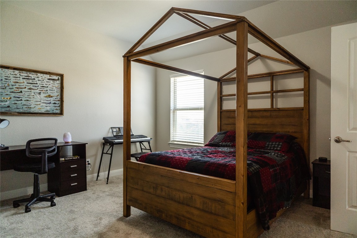 2616 Pine Branch Road Leander, TX 78641 - Photo 32 of 37 a bedroom with a bed and a window