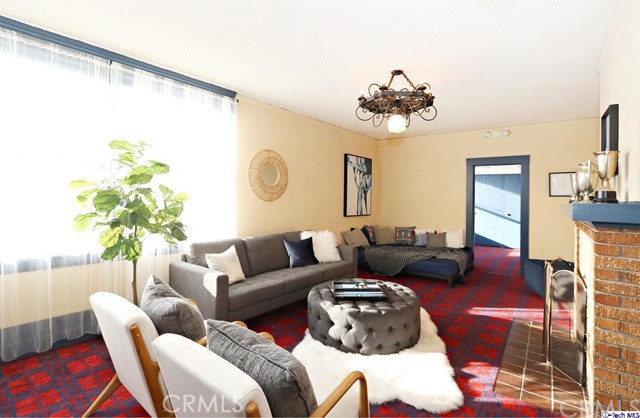 6401 Ruby Street Los Angeles, CA 90042 - Photo 15 of 27 a living room with furniture and a chandelier