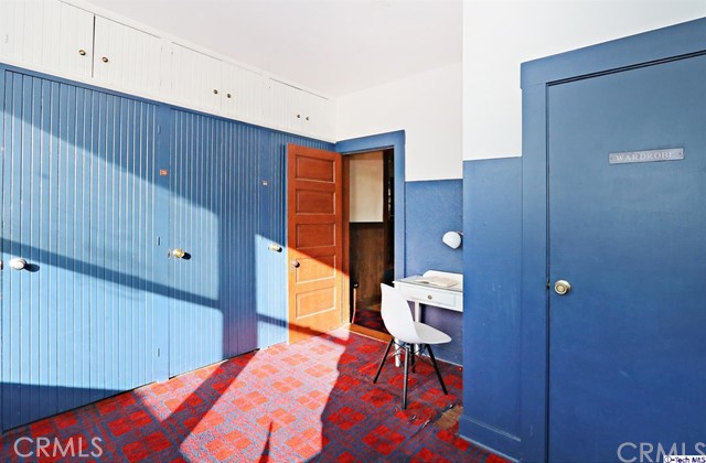 6401 Ruby Street Los Angeles, CA 90042 - Photo 19 of 27 a bedroom with a bed and a lamp on dresser