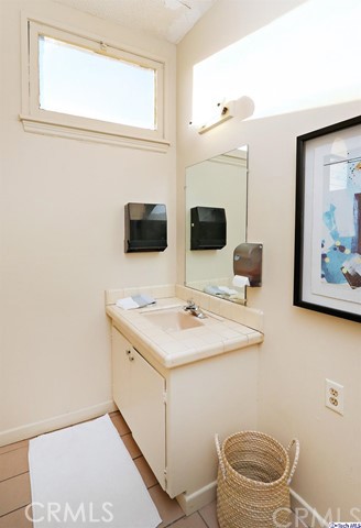 6401 Ruby Street Los Angeles, CA 90042 - Photo 21 of 27 a bathroom with a toilet sink and mirror