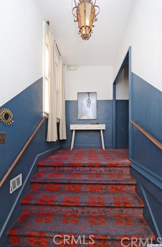 6401 Ruby Street Los Angeles, CA 90042 - Photo 9 of 27 a bedroom with a bed and a chandelier