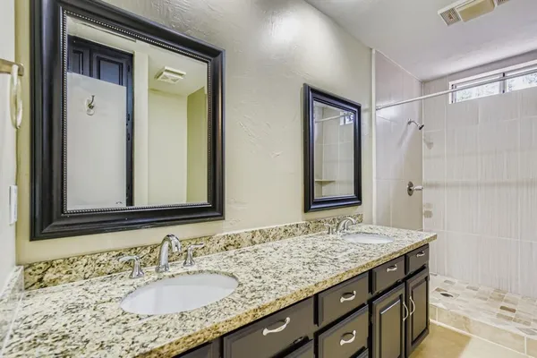 a bathroom with a granite countertop sink mirror and double