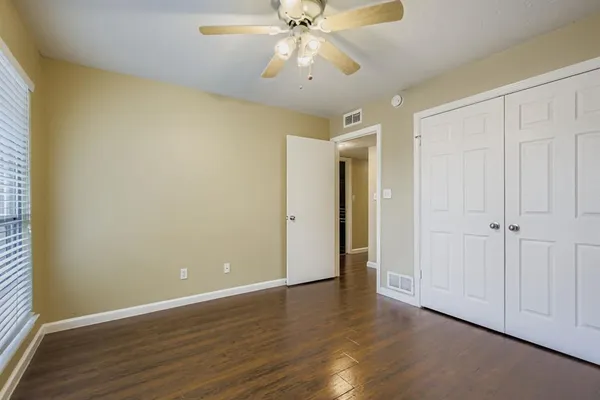 a view of an empty room and wooden floor