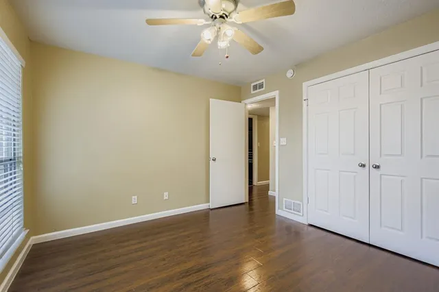 a view of an empty room and wooden floor
