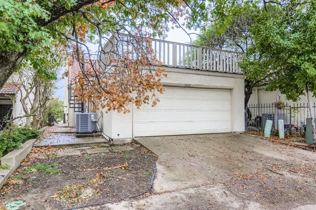 a view of a yard with large tree and wooden fence
