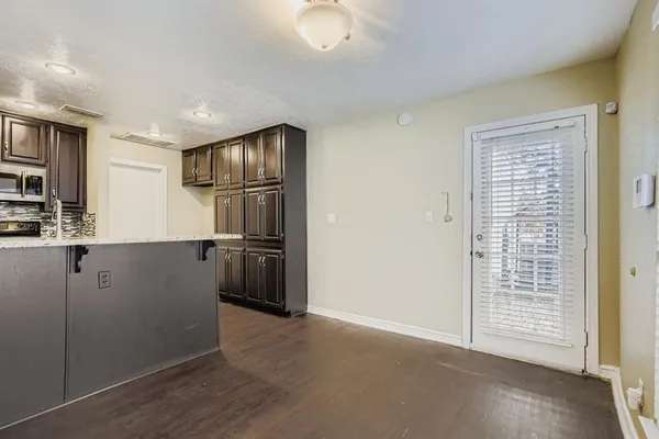 a kitchen with granite countertop cabinets and refrigerator