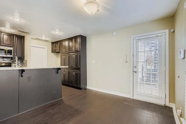 a kitchen with granite countertop cabinets and refrigerator