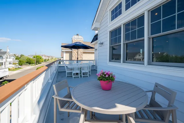 a outdoor dining space with furniture and wooden floor
