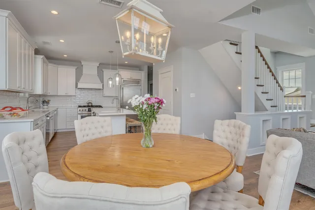 a dining room with furniture and a chandelier