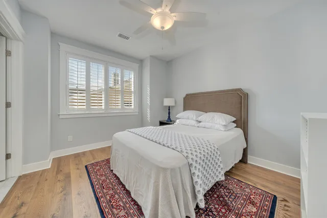 a bedroom with a large bed and a chandelier