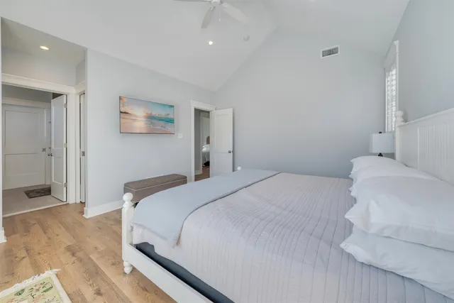 a bedroom with a bed and painting on the wall