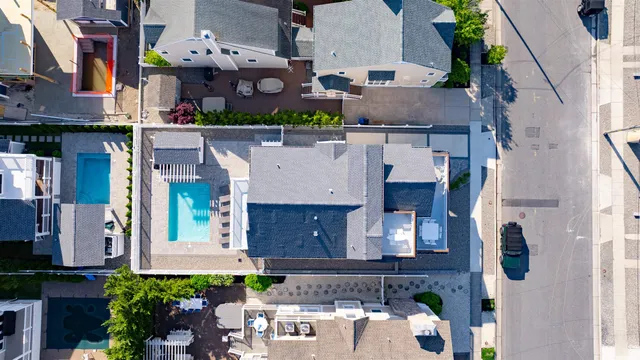 a view of a house with a small yard and large tree