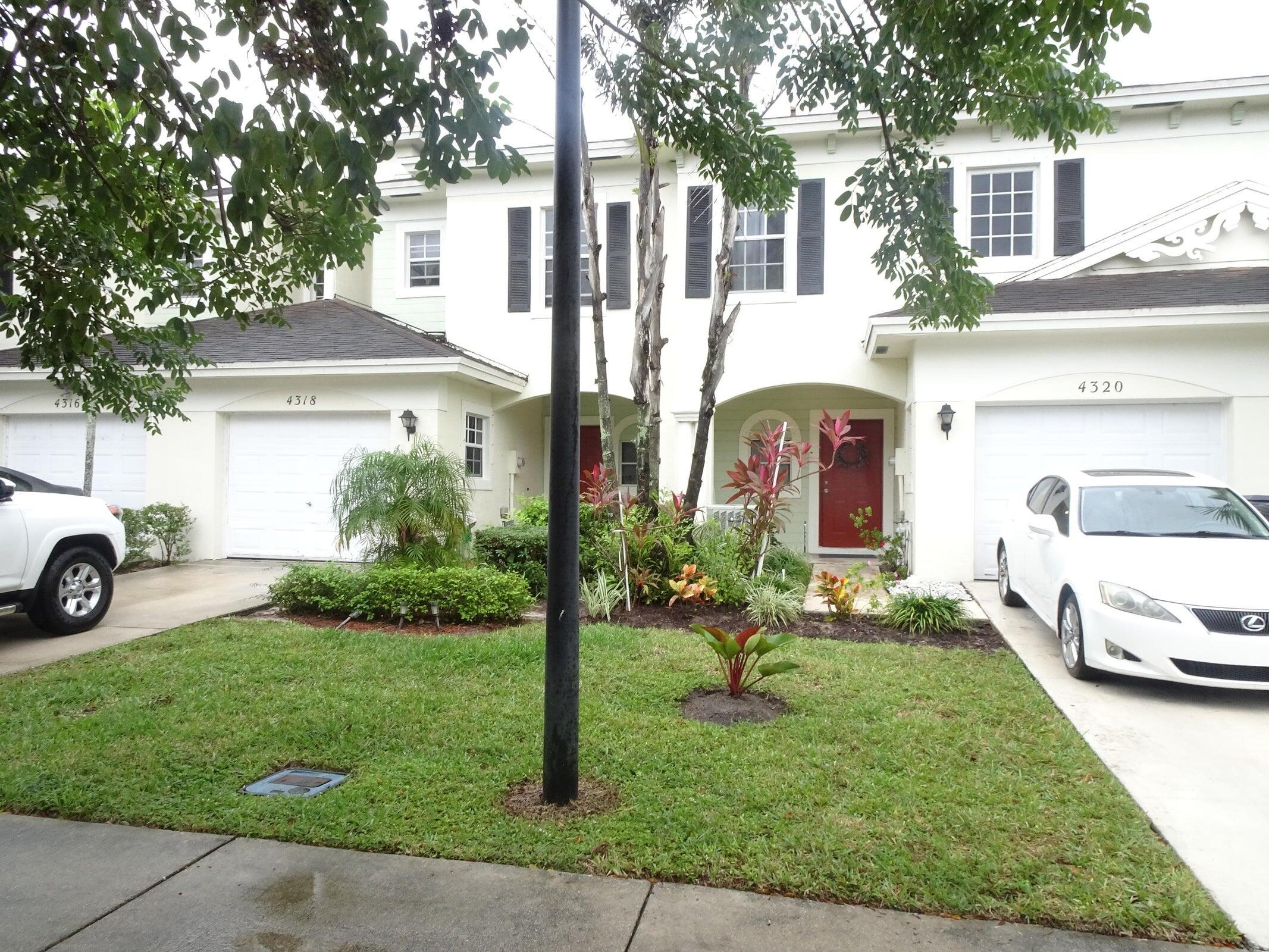 4318 Emerald Vista Lake Worth, FL 33461 - Photo 2 of 6 a front view of a house with a yard