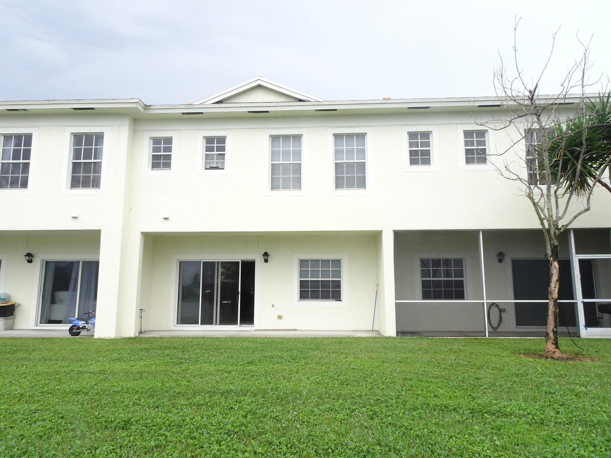 4318 Emerald Vista Lake Worth, FL 33461 - Photo 5 of 6 a front view of a house with a yard