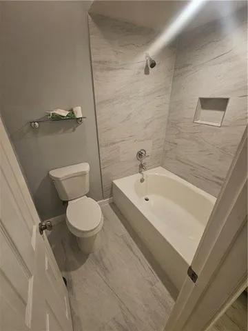 a bathroom with a toilet a sink and bathtub