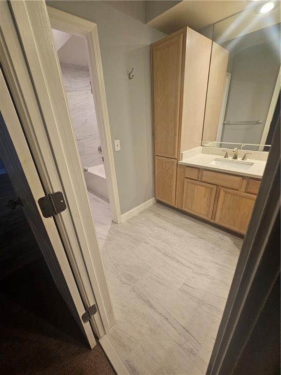 3777 Peachtree Road Northeast, Unit 1324 Brookhaven, GA 30319 - Photo 12 of 48 a bathroom with a sink a mirror and a tub