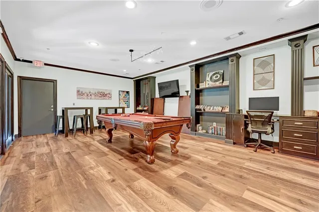 a living room with furniture a flat screen tv and a table