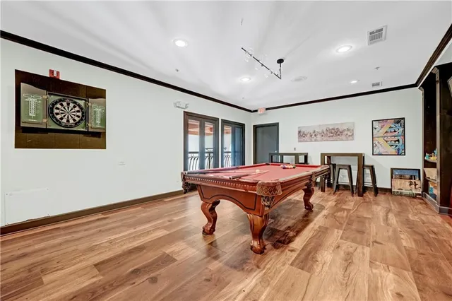 a living room with a table and a flat screen tv
