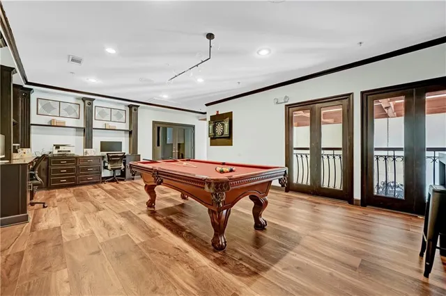 a room with pool table and windows