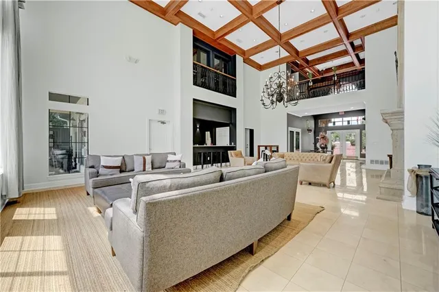 a living room with furniture a flat screen tv and a table