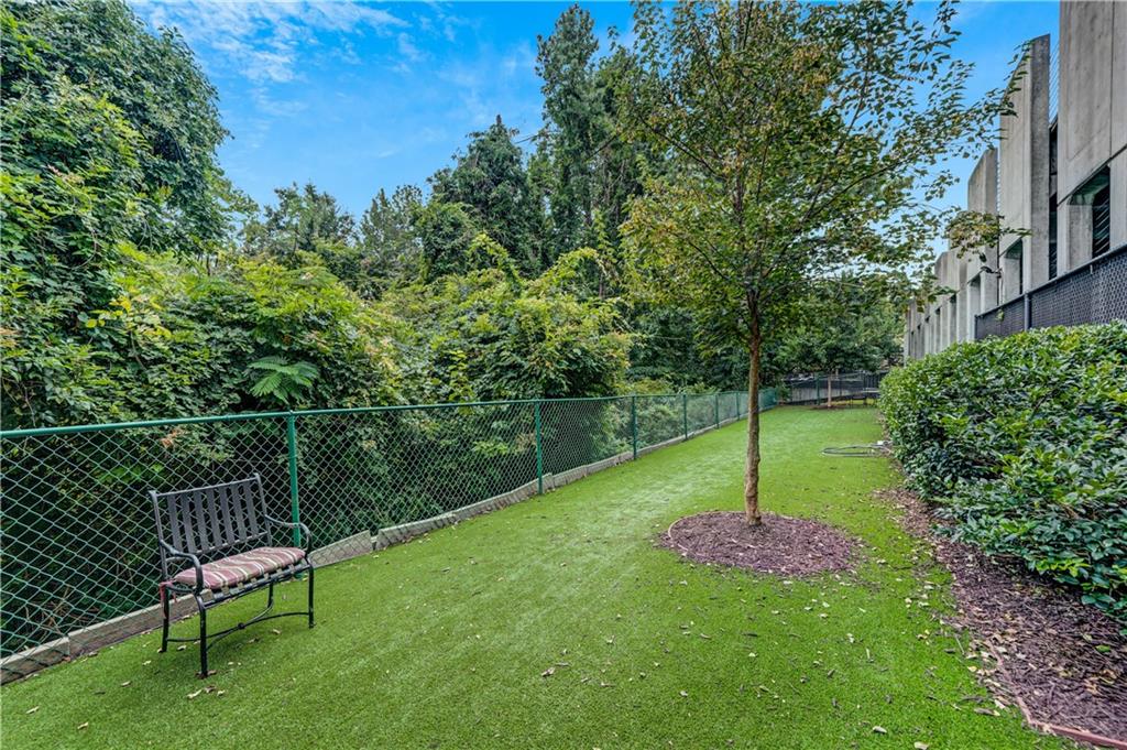 3777 Peachtree Road Northeast, Unit 1324 Brookhaven, GA 30319 - Photo 44 of 48 a view of a chair and table on the green field