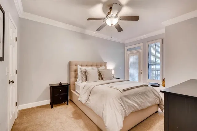 a bedroom with a large bed and a ceiling fan